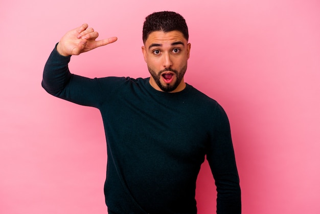 Young mixed race man isolated on pink background having some great idea, concept of creativity.