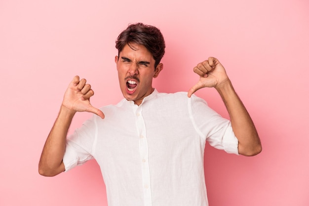 Young mixed race man isolated on white background feels proud and self confident, example to follow.