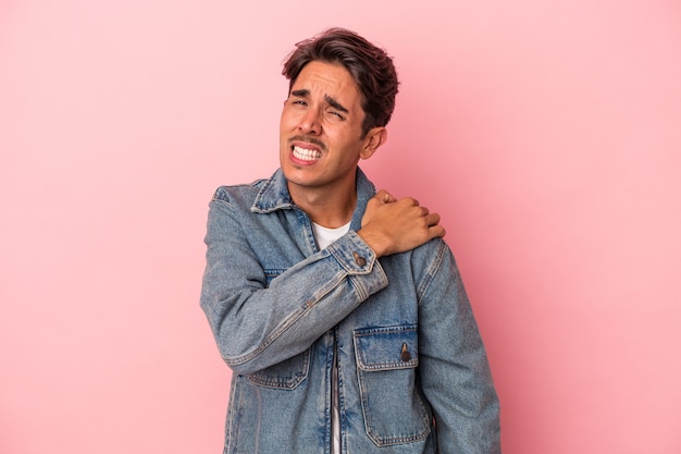 Young mixed race man isolated on white background having a shoulder pain.