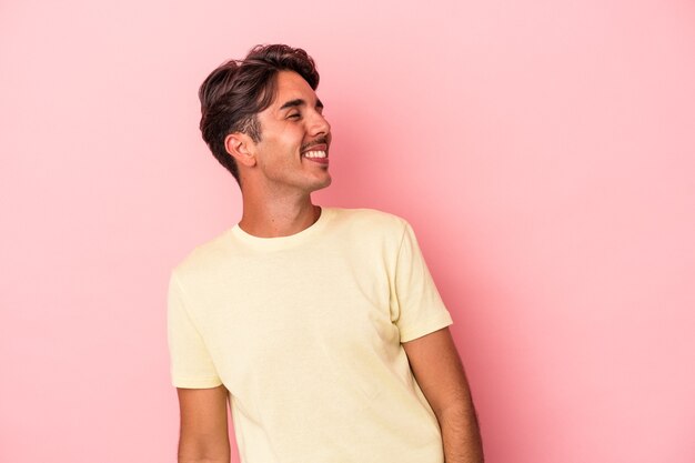 Young mixed race man isolated on white background relaxed and happy laughing, neck stretched showing teeth.