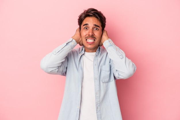Young mixed race man isolated on white background screaming with rage.