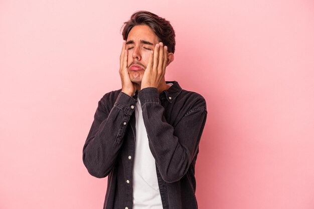 Young mixed race man isolated on white background whining and crying disconsolately.