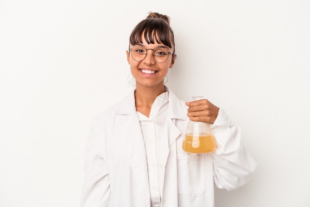 Young mixed race scientist woman holding a test tube isolated on white background  happy, smiling and cheerful.