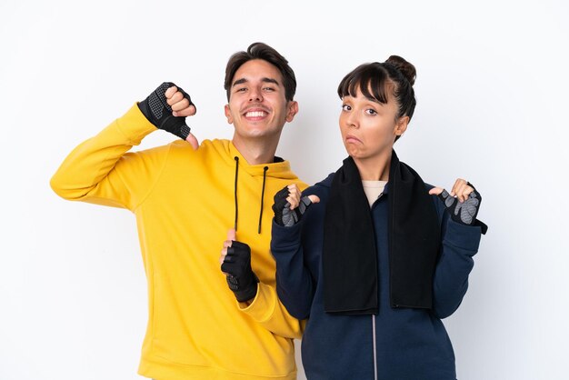 Young mixed race sport couple isolated on white background proud and selfsatisfied in love yourself concept