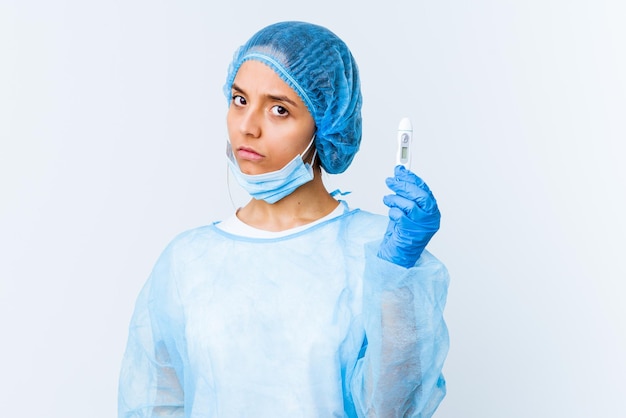 Young mixed race surgeon woman holding a thermometer isolated