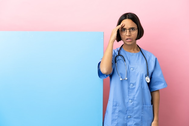 Young mixed race surgeon woman with a big banner over isolated background has realized something and intending the solution