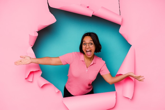 Young mixed race woman behind a broken background