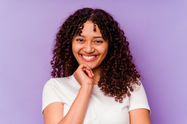 Young mixed race woman closeup isolated on purple wall