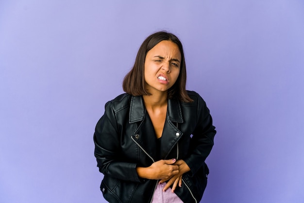 Young mixed race woman having a liver pain, stomach ache.