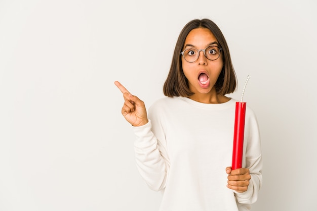 Young mixed race woman holding dynamite