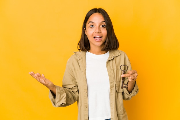 Young mixed race woman holding a key