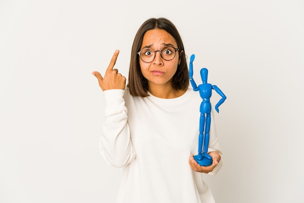 Young mixed race woman holding a mannequin