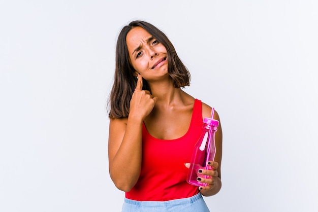 Young mixed race woman holding a milk shake isolated crying, unhappy with something, agony and confusion concept.