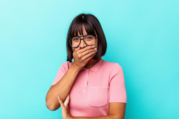 Young mixed race woman isolated on blue background scared and afraid.