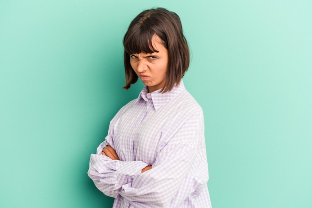 Young mixed race woman isolated on blue background showing a timeout gesture.