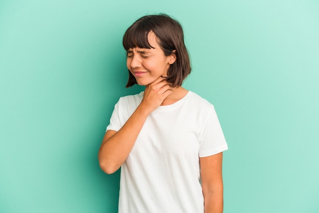 Young mixed race woman isolated on blue background suffers pain in throat due a virus or infection.