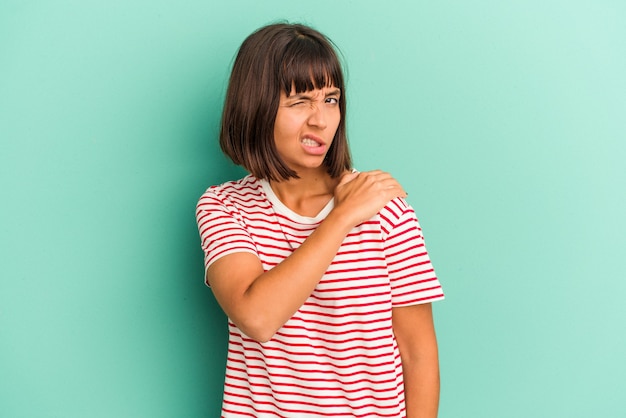 Young mixed race woman isolated on blue having a shoulder pain.