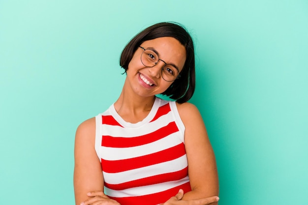 Young mixed race woman isolated on blue laughing and having fun.