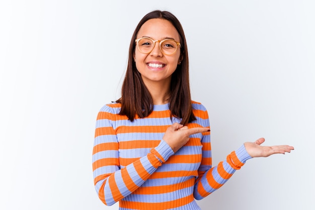 Young mixed race woman isolated excited holding a copy space on palm.