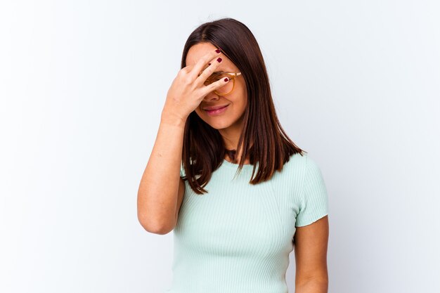 Young mixed race woman isolated having a head ache, touching front of the face.