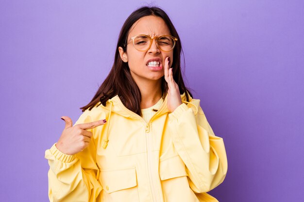 Young mixed race woman isolated having a strong teeth pain, molar ache