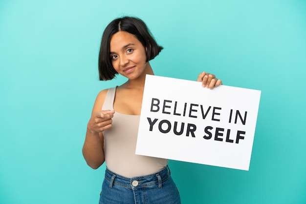 Young mixed race woman isolated holding  and pointing to paper