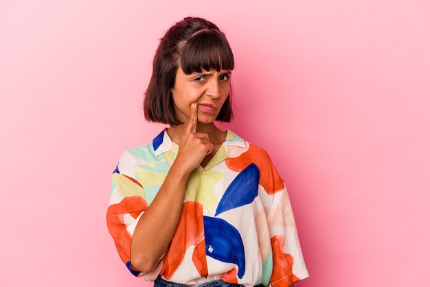 Young mixed race woman isolated on pink background contemplating, planning a strategy, thinking about the way of a business.