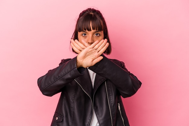 Young mixed race woman isolated on pink background doing a denial gesture