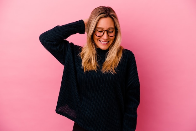 Young mixed race woman isolated on pink wall tired and very sleepy keeping hand on head.