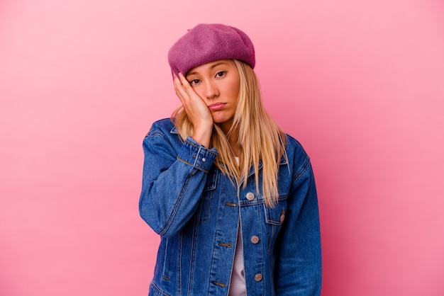 Young mixed race woman isolated on pink wall tired and very sleepy keeping hand on head.