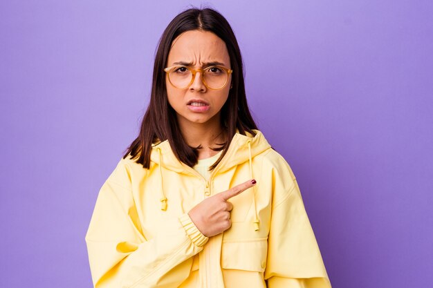 Young mixed race woman isolated pointing to the side