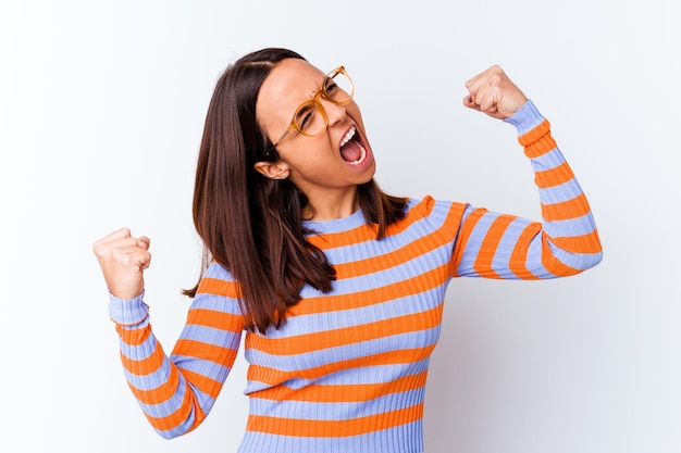 Young mixed race woman isolated raising fist after a victory, winner concept.