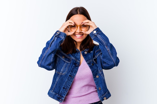 Young mixed race woman isolated showing okay sign over eyes