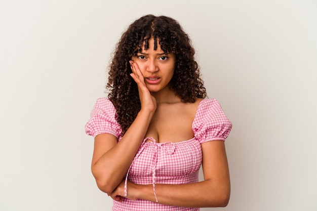 Young mixed race woman isolated on white background blows cheeks, has tired expression. Facial expression concept.