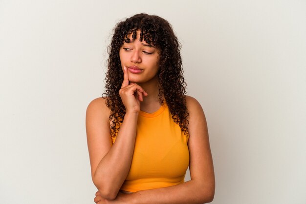 Young mixed race woman isolated on white background contemplating, planning a strategy, thinking about the way of a business.