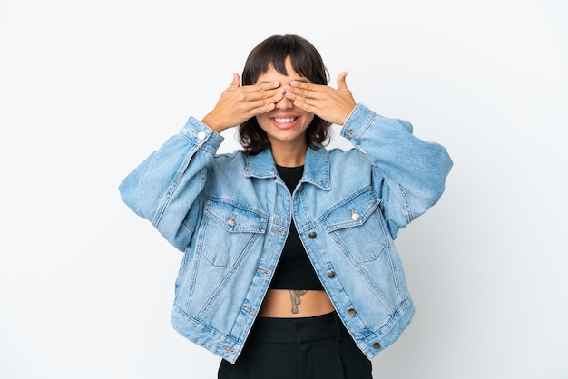 Young mixed race woman isolated on white background covering eyes by hands and smiling