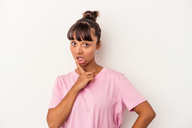 Young mixed race woman isolated on white background  looking sideways with doubtful and skeptical expression.