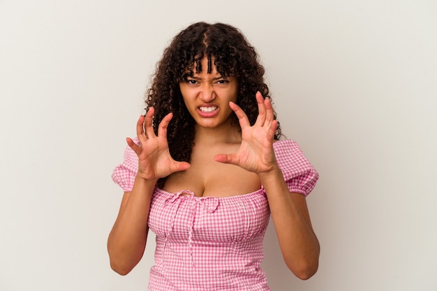 Young mixed race woman isolated on white background showing claws imitating a cat, aggressive gesture.