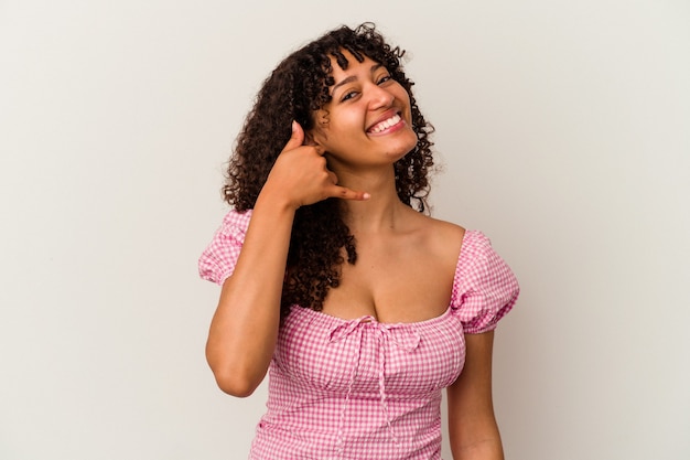 Young mixed race woman isolated on white background showing a mobile phone call gesture with fingers.