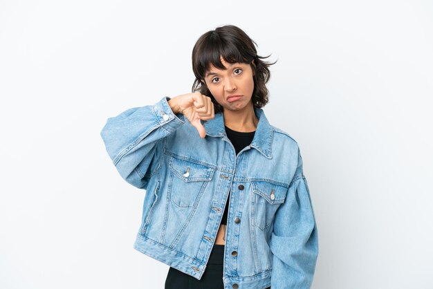 Young mixed race woman isolated on white background showing thumb down with negative expression