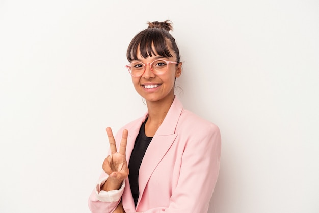 Young mixed race woman isolated on white background  showing victory sign and smiling broadly.