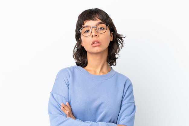 Young mixed race woman isolated on white background With glasses and arms crossed