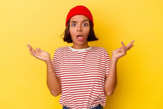 Photo young mixed race woman isolated on yellow background surprised and shocked.