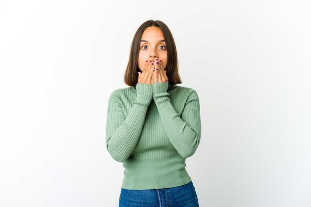 Young mixed race woman shocked covering mouth with hands.