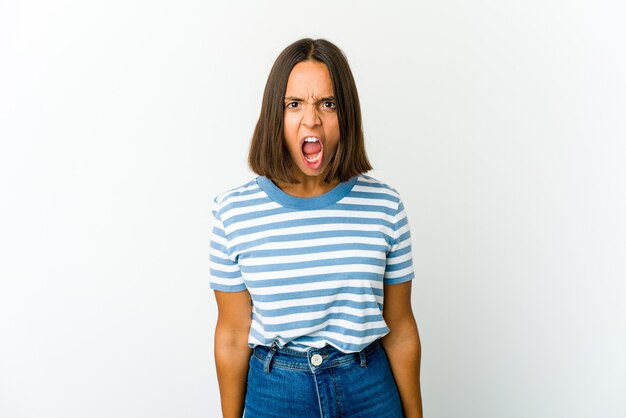 Young mixed race woman shouting very angry, rage concept, frustrated.