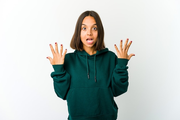 Young mixed race woman showing number ten with hands.