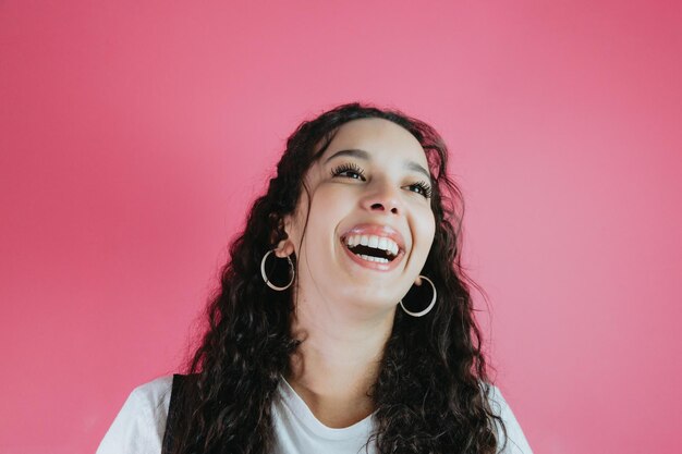 Young mixed race woman smiling, pink background removable background, minimal image, copy space, basic situations and feelings expressions