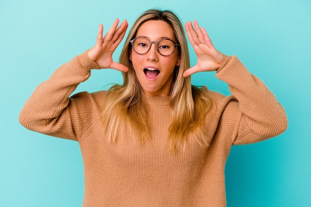 Young mixed race woman surprised and shocked.