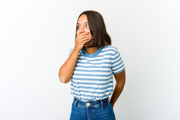 Young mixed race woman thoughtful looking to a copy space covering mouth with hand.