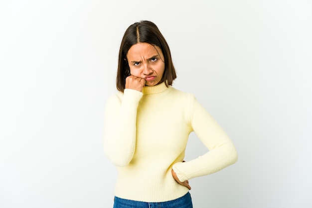 Young mixed race woman who feels sad and pensive, looking at copy space.